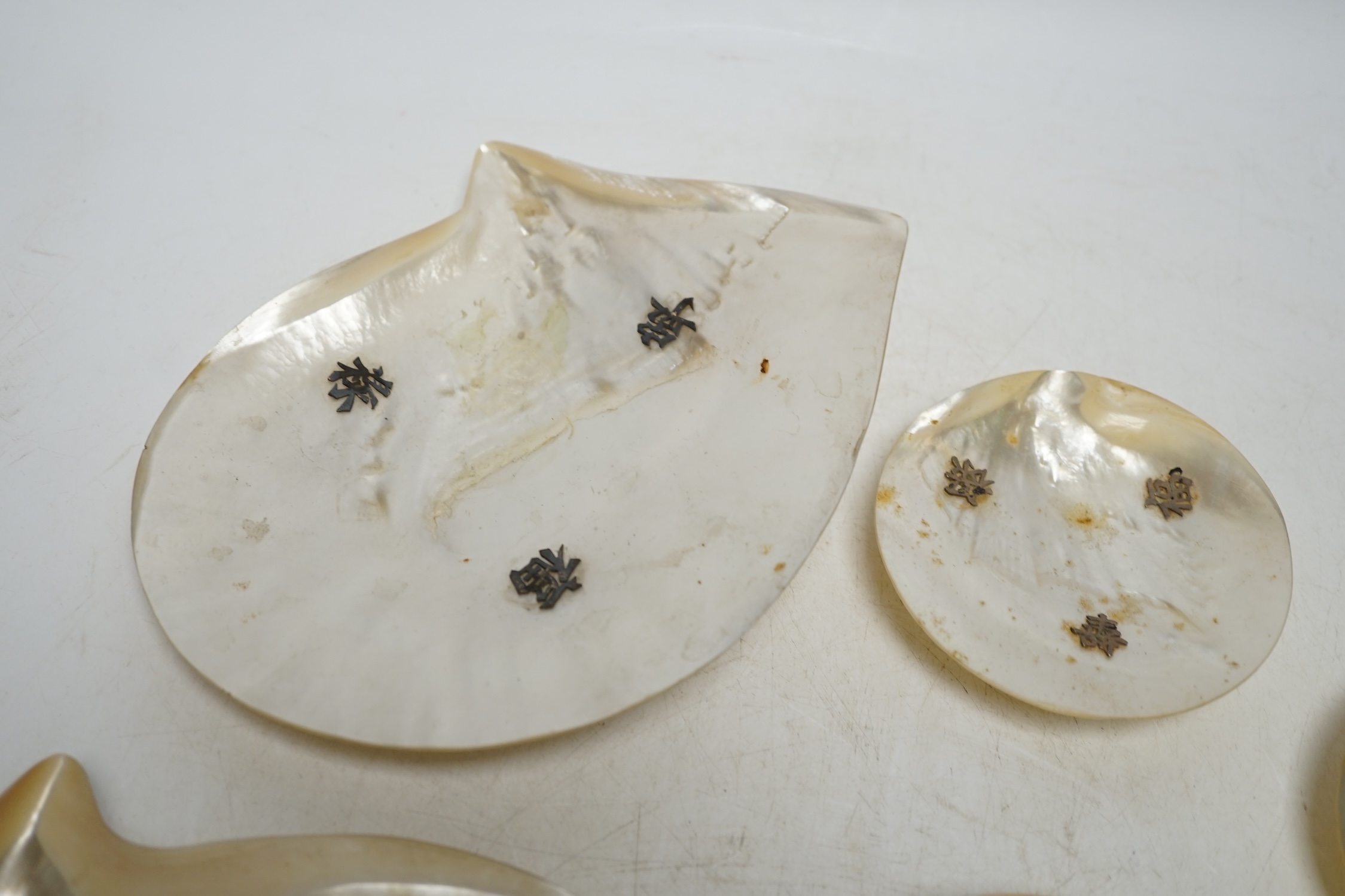 Six Chinese mother-of-pearl dishes on metal ball feet, largest 17.5cm wide. Condition - two ball feet missing on both larger shell dishes
